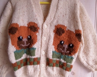 Child's Cardigan cream acrylic & 6% gold nylon threads with two rust brown teddies, one on each front for 3  - 4 years