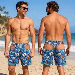 May include: Blue swim shorts featuring a repeating pattern of various cartoon creatures, including a white otter-like character, a green frog-like character, and a blue turtle-like character, with a white drawstring and cut-out side panels.