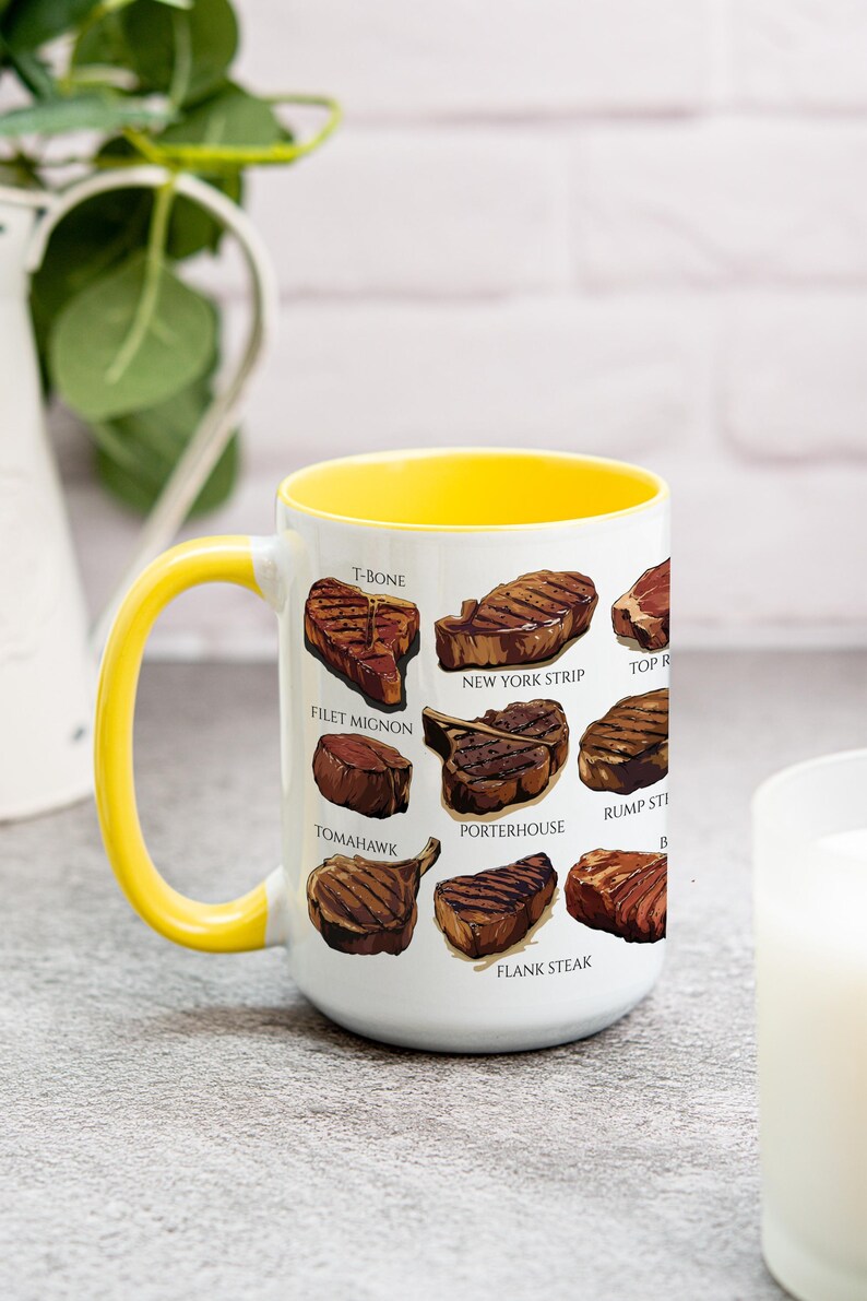 May include: White ceramic mug with a yellow interior and handle. The mug features illustrations of various cuts of steak, including T-bone, filet mignon, and New York strip. The mug is a kitchen and dining accessory.