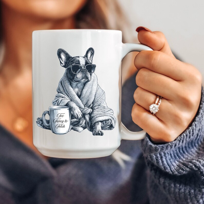 May include: White ceramic mug featuring a black and white illustration of a French Bulldog wearing sunglasses and a robe. The mug also has a smaller mug with the text "Too Fancy to Fetch".