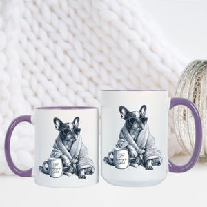 May include: Two white ceramic mugs with purple handles and rims. Each mug features a black and white illustration of a French Bulldog wearing sunglasses and a robe, holding a mug that says "Too Fancy to Fetch."