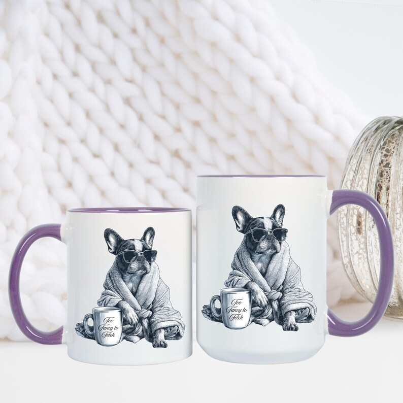 May include: Two white ceramic mugs with purple handles and rims. Each mug features a black and white illustration of a French Bulldog wearing sunglasses and a robe, holding a mug that says "Too Fancy to Fetch."
