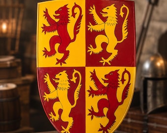 May include: A heater-style shield featuring a quartered design with alternating red and yellow quadrants. Each quadrant displays a rampant lion in the contrasting color. The shield has a smooth, glossy finish and a pointed base.