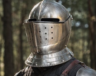 May include: A polished steel knight helmet featuring a rounded crown, a central ridge, and a visor with horizontal eye slits and a series of small circular ventilation holes. The helmet includes a flared neck guard and rests above dark quilted armor.