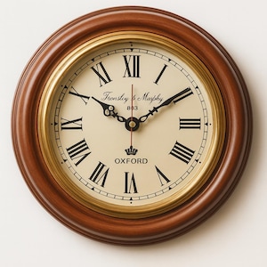 May include: A circular wall clock with a dark brown wooden surround and a cream-coloured face. The clock displays black Roman numerals, black hands, and the text "Thronsby & Marphy" and "OXFORD". It has a gold-coloured inner ring.