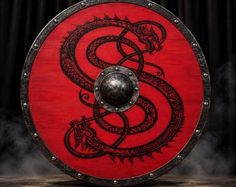 May include: A circular wooden shield with a vibrant red finish, featuring a black, intricate, intertwined dragon design. The shield is bordered by a dark, weathered metal rim secured with rivets and has a central metal boss in the middle.