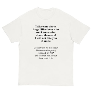 May include: A white t-shirt with black text. The text says: "Talk to me about bugs I like them a lot and I know a lot about them and I will not bite you :) smile." The shirt also includes a website and NDA reference.