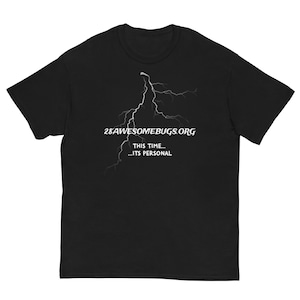 May include: Black t-shirt with a white lightning bolt design. The text "28AWESOMEBUGS.ORG" is above the lightning, with "THIS TIME... ...ITS PERSONAL" below. The shirt has a crew neck and short sleeves.