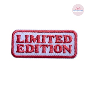 May include: A rectangular patch with the words "LIMITED EDITION" embroidered in red on a white background. The patch has a red border and is likely designed to be sewn or ironed onto clothing or accessories.