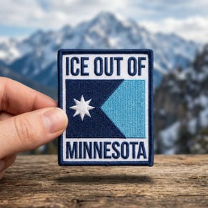 May include: A white ceramic mug with a black handle and the text "But First, Coffee" in a black, handwritten-style font. The mug sits on a white surface.