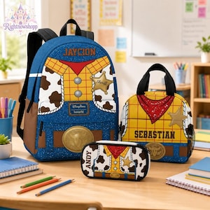 Könnte beinhalten: Ein blauer und gelber Rucksack, eine Lunchtasche und ein Federmäppchen mit Kuhfleckenmuster, rotem Bandana-Muster und goldenem Sheriffstern. Der Rucksack ist mit dem Namen JAYCION, die Lunchtasche mit SEBASTIAN und das Mäppchen mit ANDY personalisiert.
