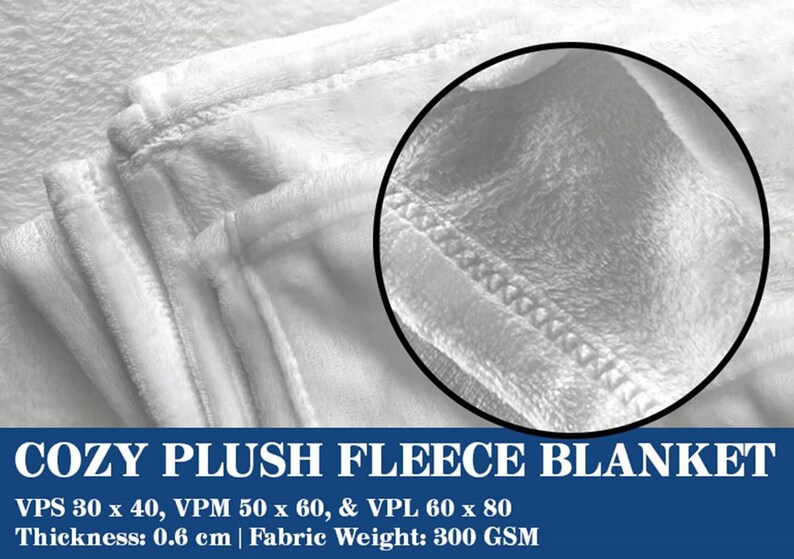 May include: A close-up of a white plush fleece blanket with stitched edges. The blanket has a soft, textured appearance. The text "COZY PLUSH FLEECE BLANKET" is displayed at the bottom, along with size and fabric details.