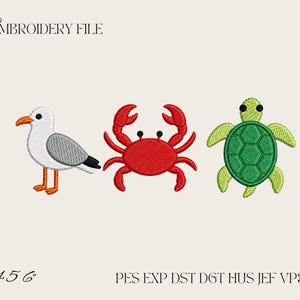 May include: An embroidery file design featuring a white and gray seagull with an orange beak and feet, a bright red crab, and a green sea turtle. The text reads EMBROIDERY FILE, 4 5 6, and PES EXP DST DGT HUS JEF VP3 XXX on a light background.