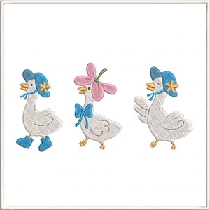 May include: Embroidered design featuring three white geese. Each goose is adorned with a hat or flower, and a bow. One goose wears blue boots. The geese have yellow beaks and are walking. The design is on a white background.