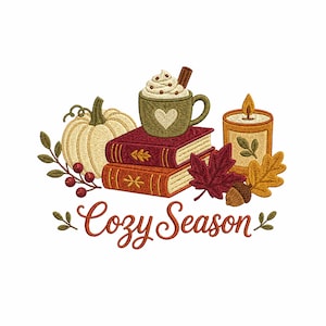 May include: An embroidery design featuring a cream pumpkin, two stacked books, a green mug with whipped cream and a cinnamon stick, and a lit candle. Red berries, autumn leaves, and an acorn surround the items. The text reads Cozy Season.