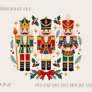 May include: An embroidery file design featuring three nutcracker figures in red, green, and blue uniforms with gold accents, surrounded by holly leaves, red berries, and gold stars. The text reads EMBROIDERY FILE, 4 5 6, and PES EXP DST DGT HUS JEF VP3 XXX.