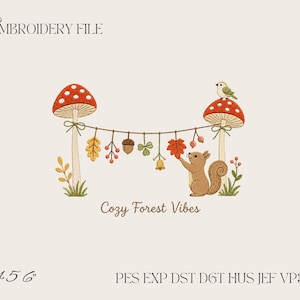 May include: An embroidery file design featuring two red and white spotted mushrooms connected by a string adorned with leaves, an acorn, berries, and a bell. A brown squirrel stands by one mushroom, and a small bird sits atop it. Text reads "EMBROIDERY FILE", "Cozy Forest Vibes", "4 5 6", and "PES EXP DST DGT HUS JEF VP3 XXX".