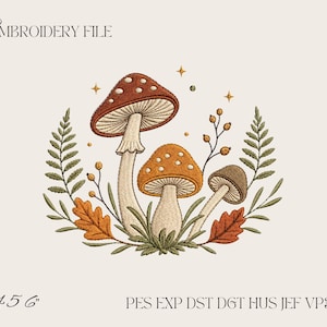 Peut inclure: Un motif de fichier de broderie représentant trois champignons dans des tons de brun et d'orange, entourés de frondes de fougère, de feuilles de chêne et de petites baies. Le texte EMBROIDERY FILE, 4 5 6 et les formats PES EXP DST DGT HUS JEF VP3 XXX sont visibles.