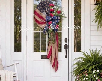 Patriotic American Flag Wreath— vintage scarf flag, red geraniums, white flowers, patriotic bow, grapevine base. Also available in white
