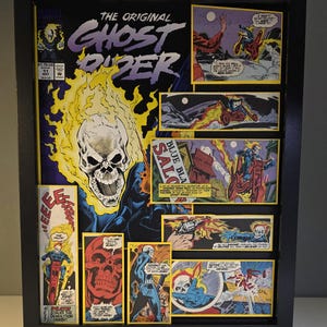 May include: Framed comic book art featuring the Ghost Rider. The artwork includes the comic book cover with the title "The Original Ghost Rider" and several panels depicting action scenes. The frame is black.