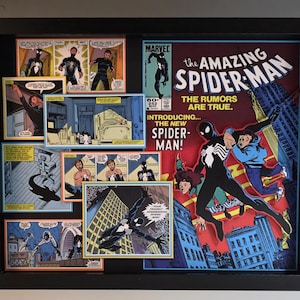 May include: A black shadow box frame containing a 3D layered display of The Amazing Spider-Man comic book cover number 252. The artwork features Spider-Man in a black suit, various comic panels, and text including The Rumors Are True.