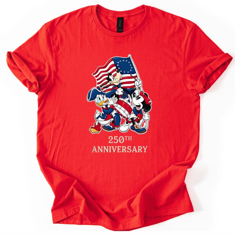 May include: A red t-shirt featuring Mickey Mouse, Donald Duck, and Goofy holding a flag with the American flag design. The text "250th Anniversary" is printed below the characters. The shirt is made of a soft material.