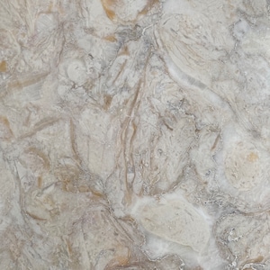 May include: A close-up of a light gray and brown marble surface with a swirling pattern.