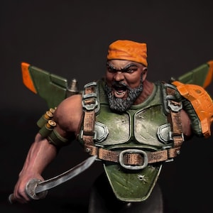 May include: A detailed miniature bust of a warrior with an orange bandana, a gray beard, and a stern expression. He wears a green and brown tactical vest with a jetpack and holds a katana. The figure is painted with realistic shading and highlights.