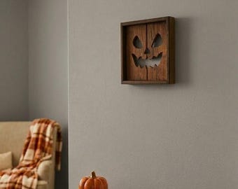 Rustykalna drewniana dekoracja ścienna z wyciętą twarzą Jacka O'Lantern – dekoracja na Halloween w stylu wiejskim