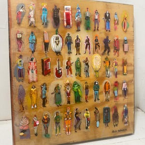 May include: A wooden art piece featuring numerous sticker-like figures of people, objects, and symbols. The figures are arranged on a wooden surface with a clear, glossy coating. The artwork includes a variety of colors and styles, with the artist's signature in the bottom right corner.