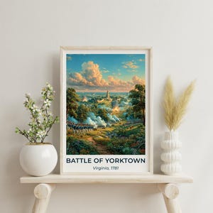 May include: A framed art print depicting the Battle of Yorktown in Virginia, 1781. The scene shows soldiers in formation amidst a landscape with smoke, trees, and a sunset sky. The text BATTLE OF YORKTOWN Virginia, 1781 is printed at the bottom.