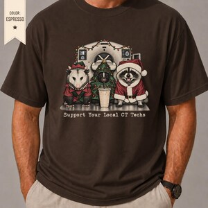 May include: An espresso brown t-shirt featuring a graphic of an opossum in an elf outfit, a skunk in a Christmas tree costume, and a raccoon in a Santa suit in front of a CT scanner. The text reads: Support Your Local CT Techs.