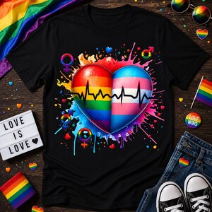 May include: Black t-shirt featuring a heart design split into rainbow and transgender flag colors, with a heartbeat line. The shirt includes gender symbols and the text "LOVE IS LOVE" on a light box. Accessories include a rainbow flag and sunglasses.