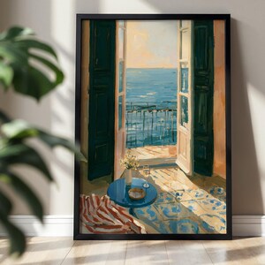 Könnte beinhalten: Ein gerahmtes Gemälde, das eine offene Balkontür mit Blick auf das blaue Meer zeigt. Die Szene umfasst dunkelgrüne Fensterläden, einen kleinen runden blauen Tisch mit einem Glas und Blumen, ein gestreiftes Textil und einen sonnigen Fliesenboden.