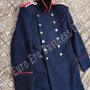 May include: A navy blue military-style coat with gold buttons and red trim. The coat features a double-breasted design, a high collar with red lining, and epaulets with red and white accents. The text "Euro Era Business Co" is visible.