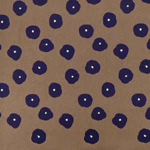 May include: A tan fabric featuring a repeating pattern of dark navy blue circular shapes. Each navy blue circle contains a small, centered white dot, creating a consistent, evenly spaced design across the entire surface of the textile material.