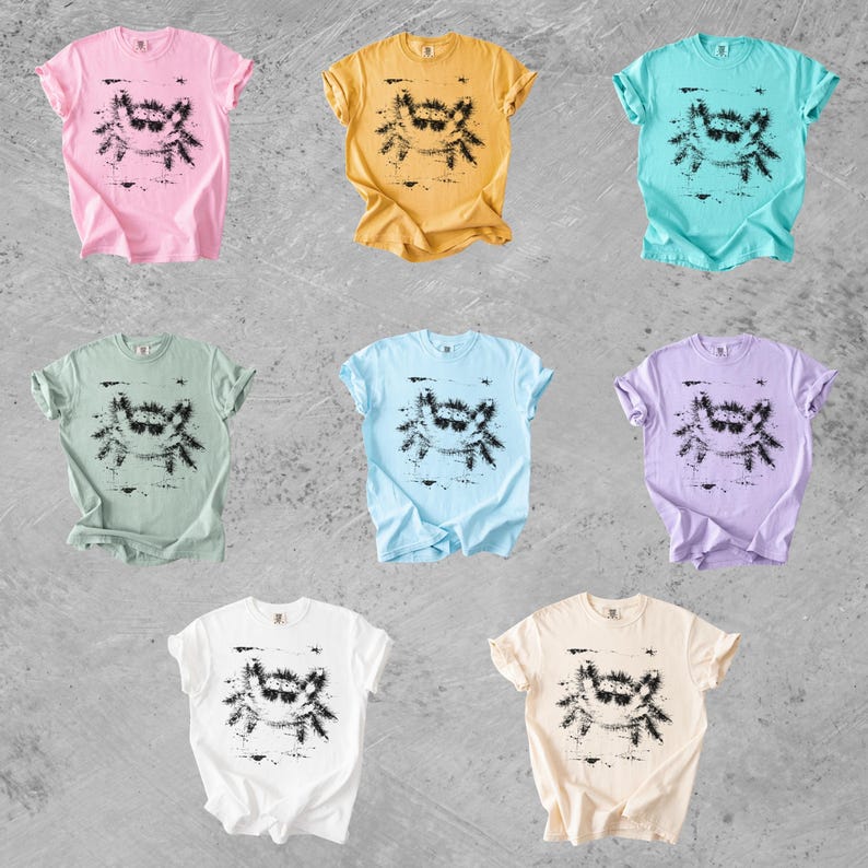 Puede incluir: Ocho camisetas de manga corta y cuello redondo en varios colores pastel y s&oacute;lidos, incluyendo rosa, amarillo, turquesa, verde claro, azul claro, lavanda, blanco y crema. Cada camiseta presenta un estampado gr&aacute;fico negro de un cangrejo con gafas.