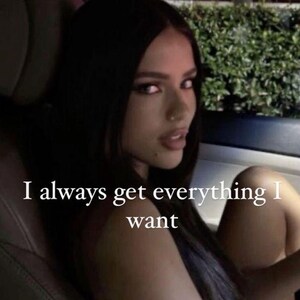 May include: A woman with dark hair and makeup is seen in a car, looking towards the camera. The text "I always get everything I want" is overlaid on the image in white text.