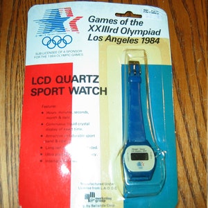 VINTAGE 1984 Montre numérique LCD LCD neuve sur carte, XXIII Jeux Los Angeles scellée - Bleu
