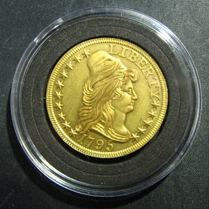 May include: A set of three ceramic mugs with a speckled, matte finish. The mugs are in shades of cream, light gray, and dark gray. Each mug has a simple, minimalist design, perfect for coffee or tea.