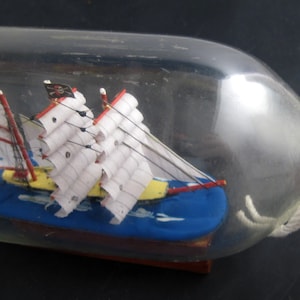 Pirate Ship in a Bottle with Cannonball Holes in the Sails!  by Hampton Nautical 7&quot; Long