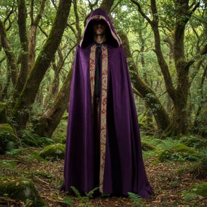 May include: A long, hooded cloak in a deep purple hue. The cloak features a decorative gold and burgundy trim along the edges of the hood and front opening. The cloak is made of a soft, flowing fabric, suitable for cosplay or costume events.