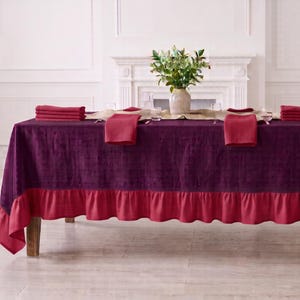 May include: A rectangular tablecloth in deep purple with a contrasting bright red ruffled border. The table is set with matching red folded napkins, a central beige runner, and a vase of green foliage. The text PATTERN-08 is visible.