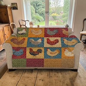 May include: A patterned sofa cover with a patchwork design. Each square features a different illustration of a chicken in various colours. The squares are in shades of green, blue, yellow, and red. A decorative item for the home.