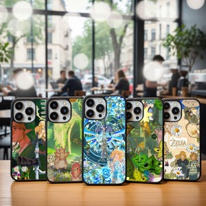 May include: A collection of five phone cases with unique designs. The cases feature colorful illustrations of characters and scenes, with a black border. The backgrounds include floral patterns, characters, and text. The cases are displayed on a wooden surface.