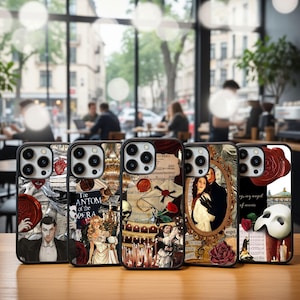 May include: A collection of phone cases featuring designs inspired by the musical "The Phantom of the Opera." The cases display images of characters, roses, musical notes, and the iconic mask. The cases are black with a glossy finish.