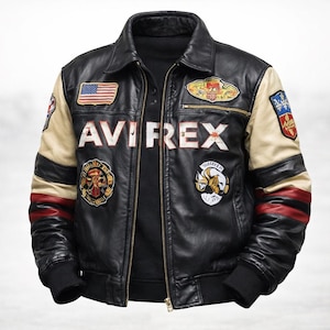 May include: A black leather jacket featuring the text AVIREX across the chest, a front zipper, and multiple colorful embroidered patches. The sleeves are accented with beige and red stripes, and the cuffs and hem are finished with black ribbed knit.
