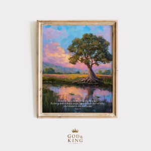 May include: A framed art print of a landscape painting. The image shows a tree reflected in a pond, with a colorful sky and fields. The artwork includes text from Psalm 1:3. The frame is light brown. The God & King Studio logo is at the bottom.