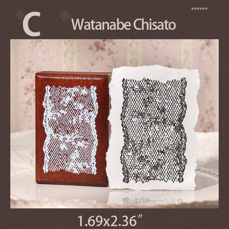 May include: A rectangular wooden rubber stamp with a dark brown finish and a white lace pattern on the face. Next to it is a white piece of paper with a black ink impression of the same lace design. The text C Watanabe Chisato 1.69x2.36" is visible.