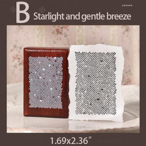 May include: A rectangular wooden stamp with a dark brown finish and a white rubber surface featuring a grid pattern with small dots, accompanied by a white paper print showing the black grid design. The text B Starlight and gentle breeze 1.69x2.36" is visible.